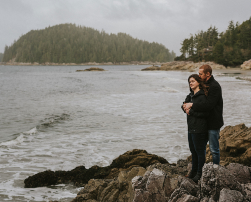 Couple standing and looking out at the ocean from Tonquin Beach