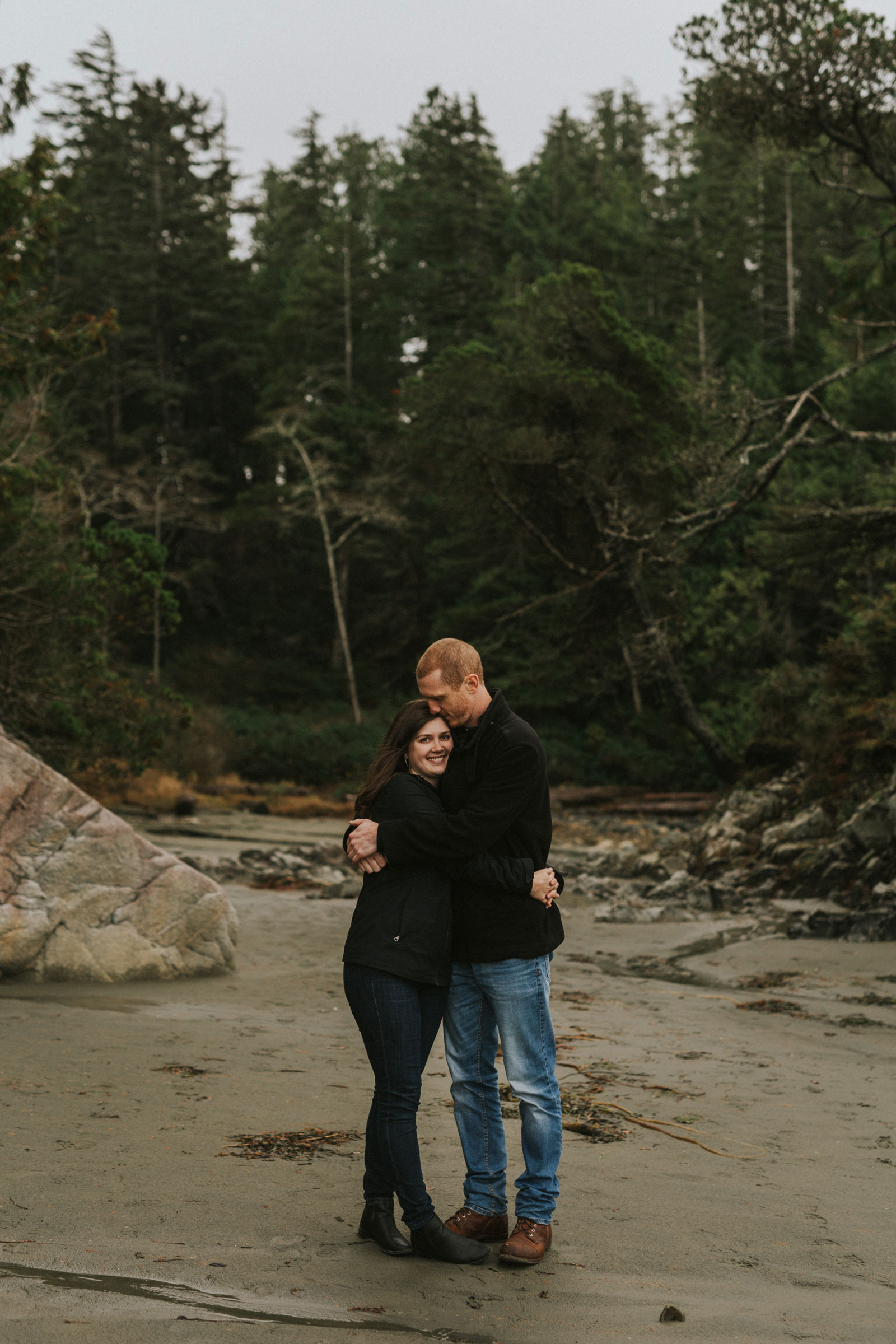 Engaged couple hugging at Tonquin Beach