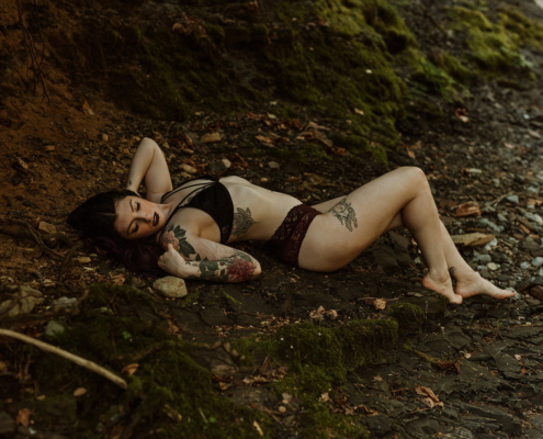 Tattoo'ed model laying down