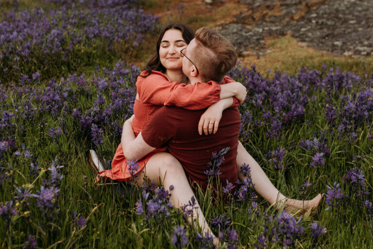 Couple cuddling in the wildflowers